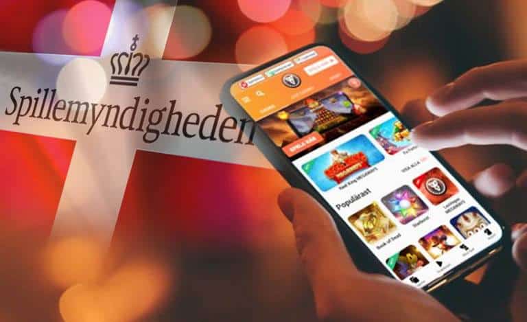 Online casinospel på mobiltelefonen framför den danska flaggan